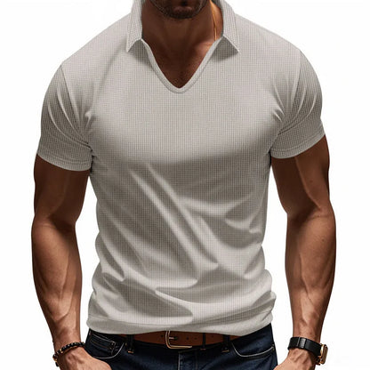 Man modelling a loose-fit apricot coloured V-neck short-sleeve T-shirt for casual summer wear.
