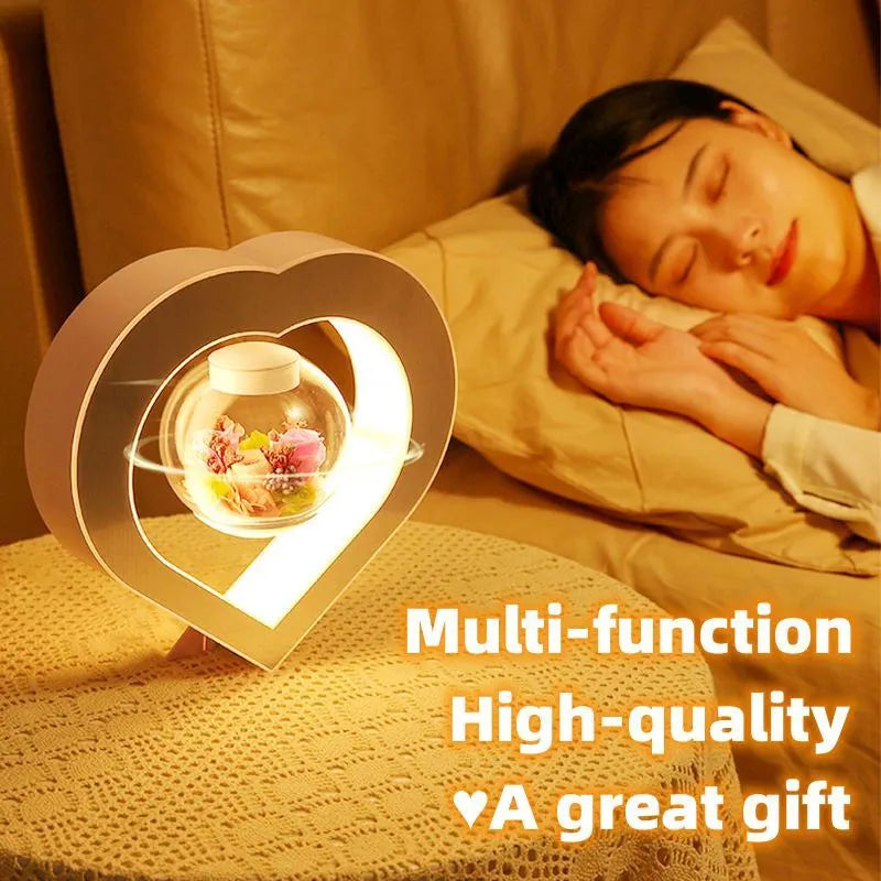 Pink rose eternal flower floating in magnetic levitation LED night light with triangular base and touch control
