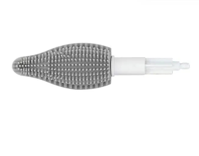 Green electric cleaning brush with multiple brush heads on a kitchen worktop.