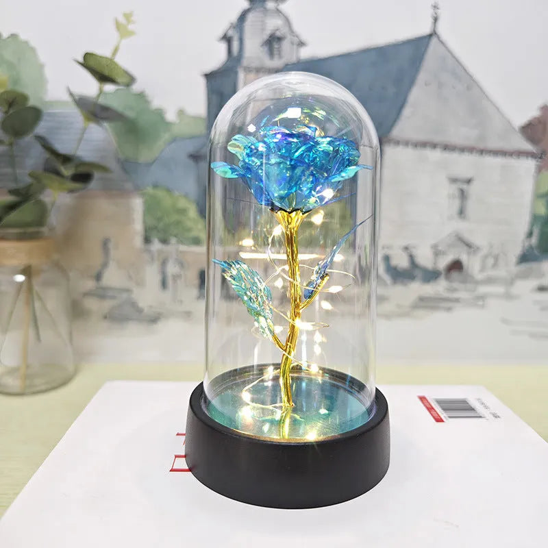 Glass cover small night lamp with plastic flowers, 15cm height, black base, showing colour light options