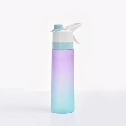 White spray water bottle with black leakproof lid and handle strap on a table