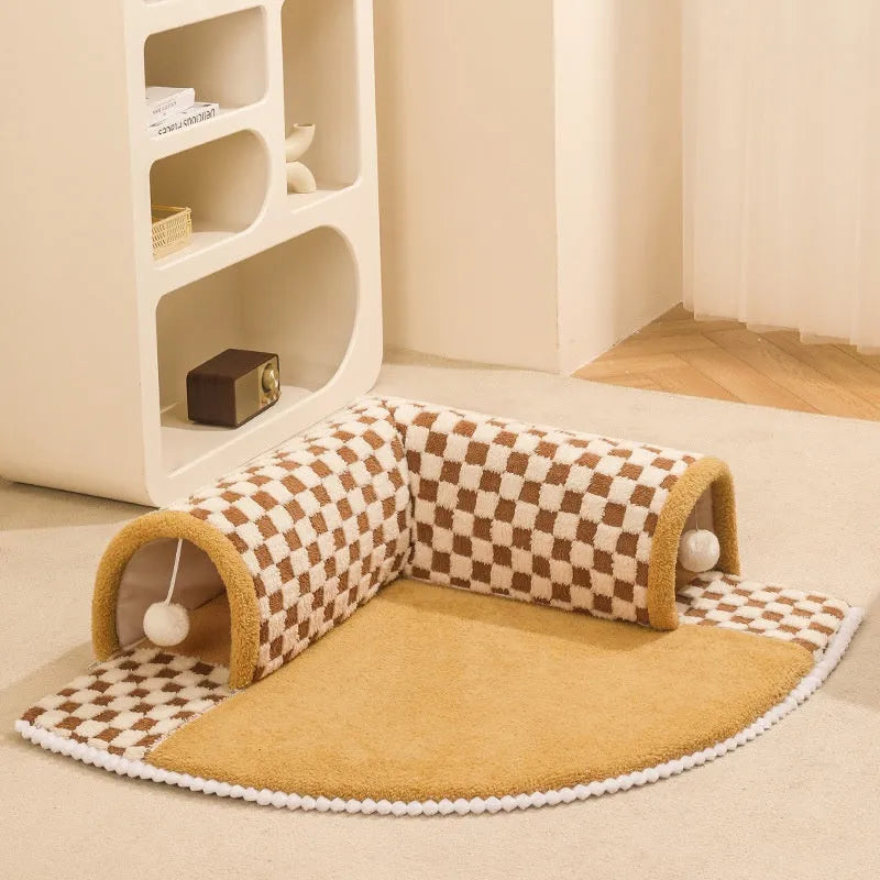 Brown plush plaid cat tunnel bed with central mat showing non-slip bottom and tunnel opening