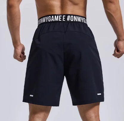 Men's loose black sports shorts with elastic waist and letter detail, shown front and back.