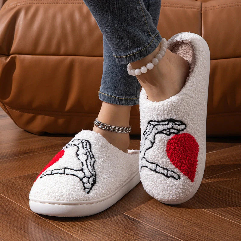 Halloween-themed skull-hand slippers in black and white, featuring non-slip soles for indoor comfort.