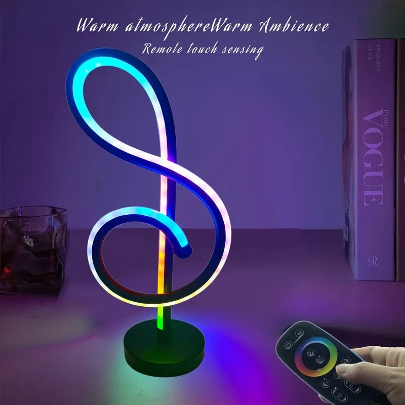 Black remote-controlled LED night light with Bluetooth remote on a bedside table.