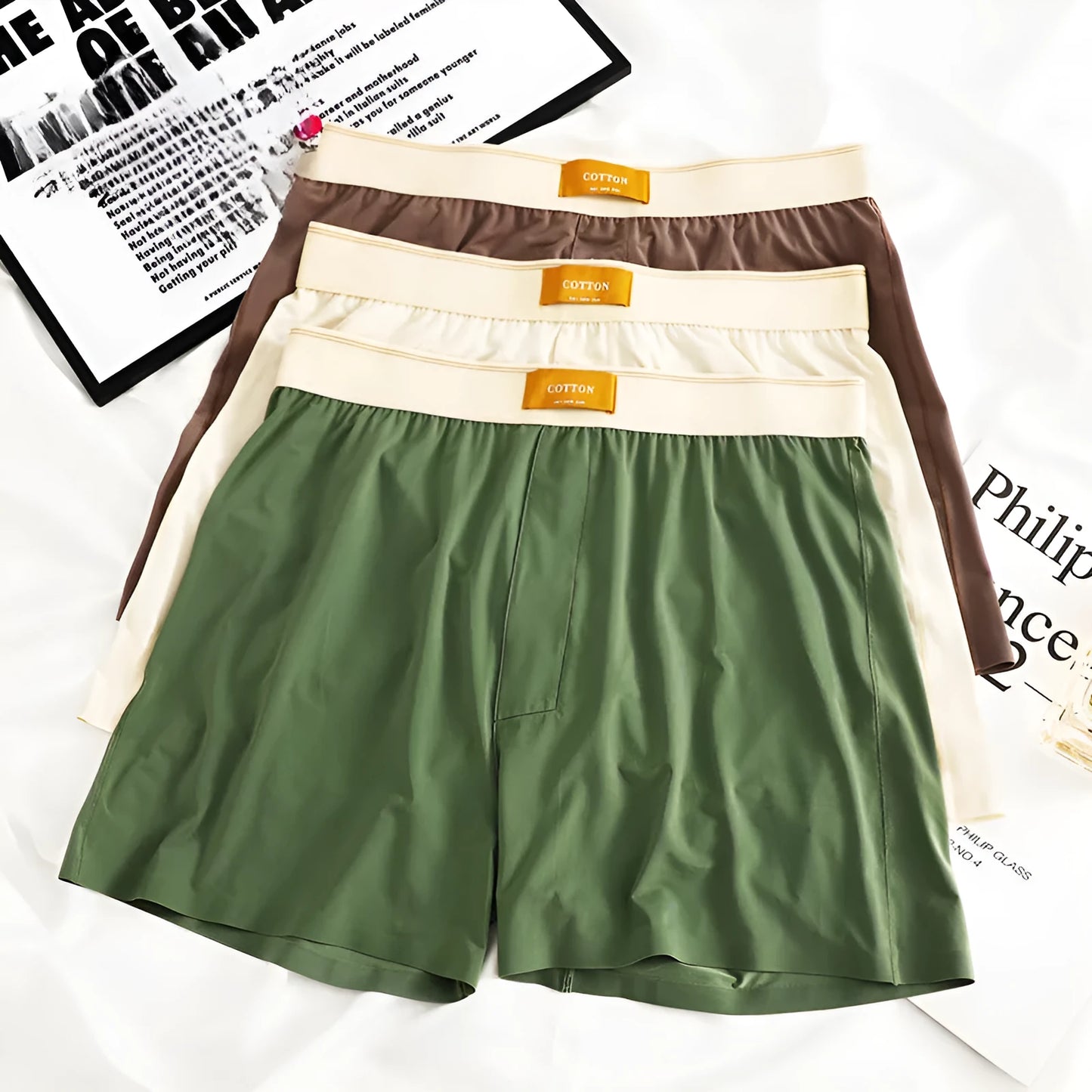 Pack of three pairs of solid colour men's ice silk briefs on a white background