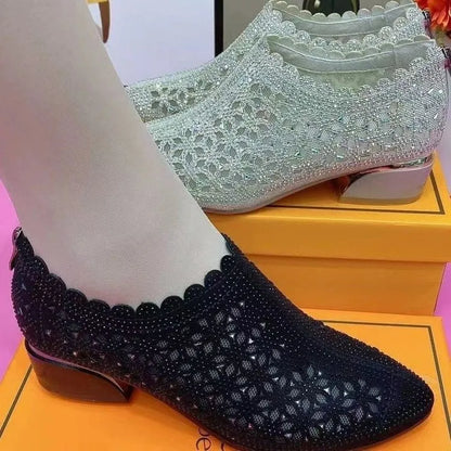 Women's chunky heel shoes with hollow-out upper, frosted full diamond detailing, round toe, canvas upper, and rubber sole.
