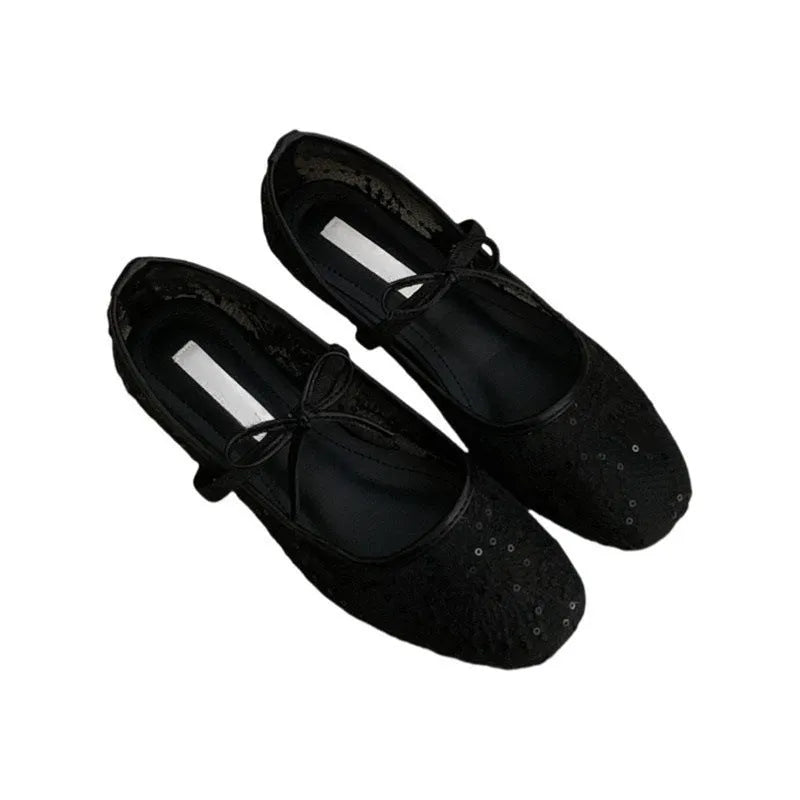Pink Mary Jane evening shoes with flat lace, mesh upper, and a mid heel on a rubber sole.