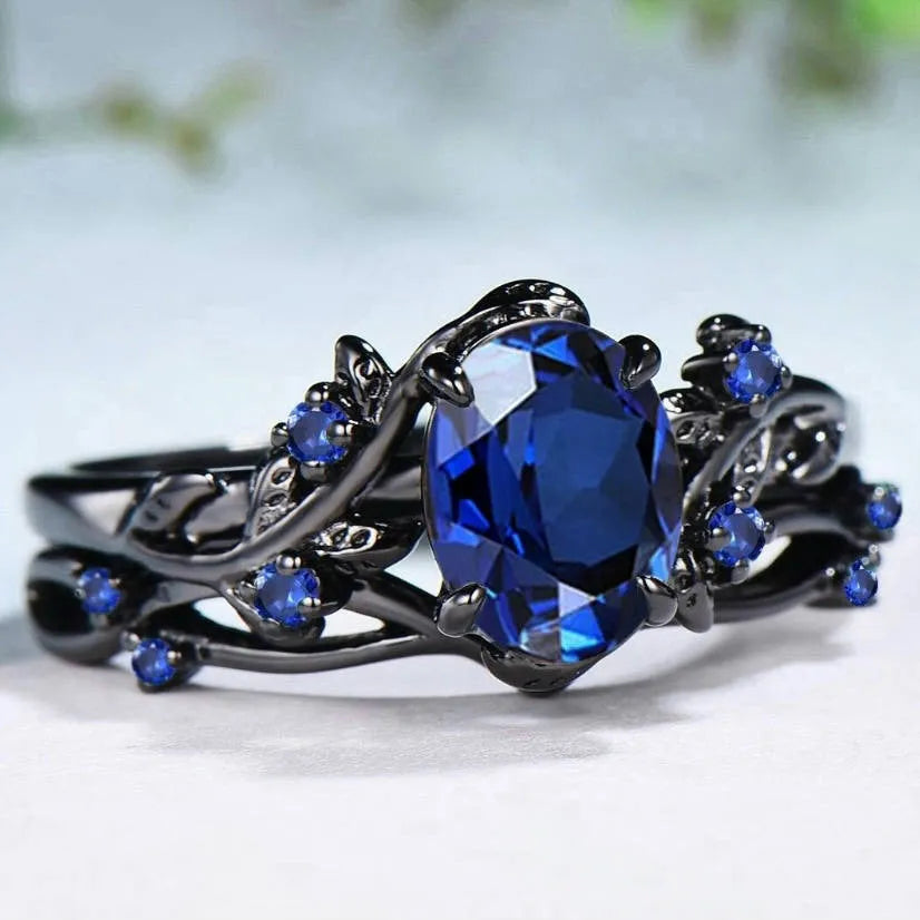 Geometric black women's couple ring with navy blue rhinestone inlay showing side profile