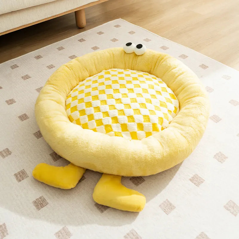 Blue plush kennel bed for dogs or cats with raised sides, shown in a home setting.