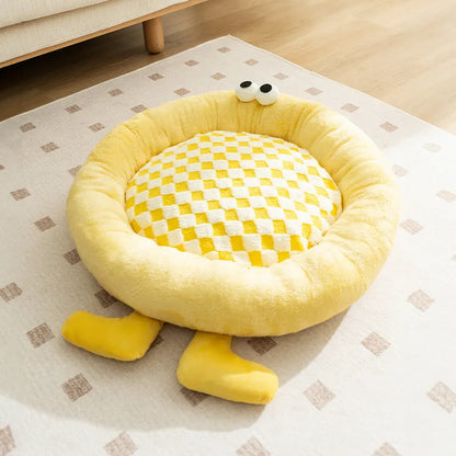 Blue plush kennel bed for dogs or cats with raised sides, shown in a home setting.
