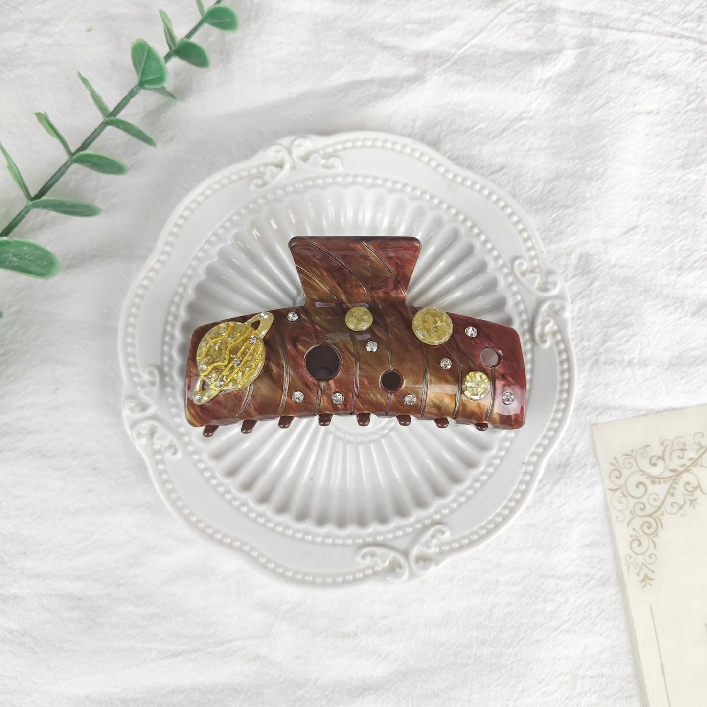 Oversized star barrettes in starry sky colours showing minimalist design and irregular elements