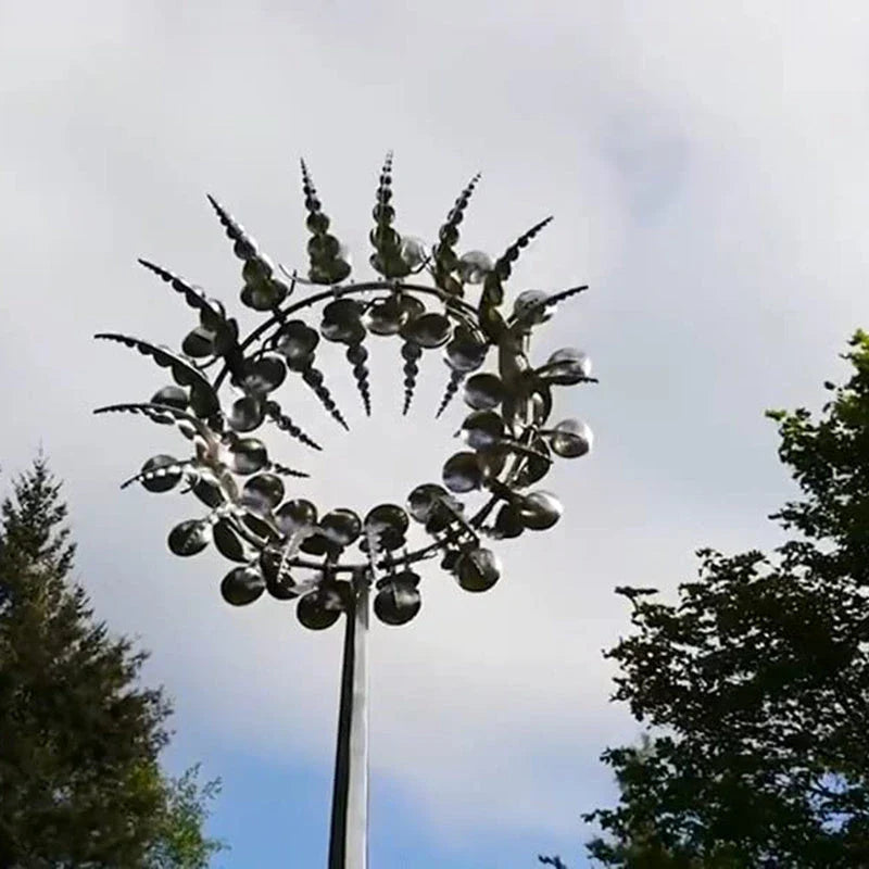Elegant stainless steel outdoor windmill spinner with dual-layered blades rotating in opposite directions, creating a mesmerising display in the garden
