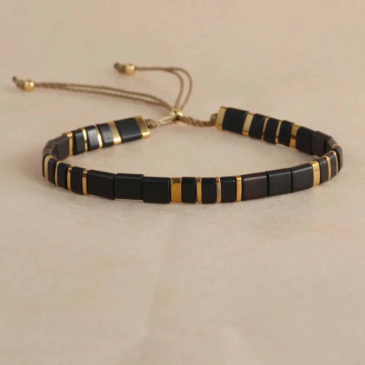 Geometric glass beaded pull bracelet in multiple colours including milky white, black, retro green, light blue, and red