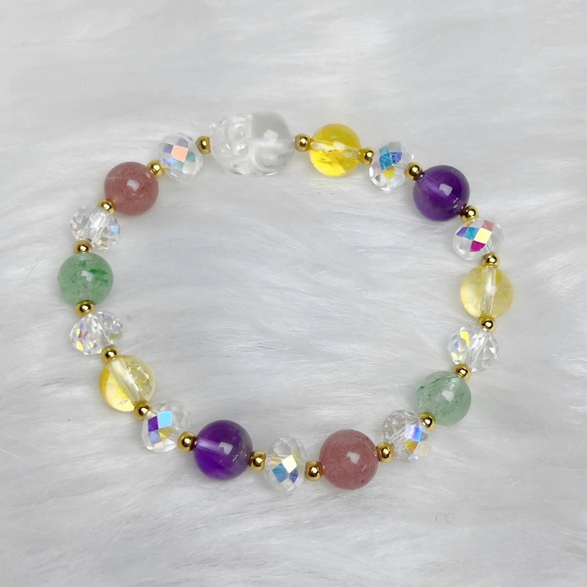 Close-up of a handmade crystal bracelet with a detailed nine-tailed fox design on a wrist.