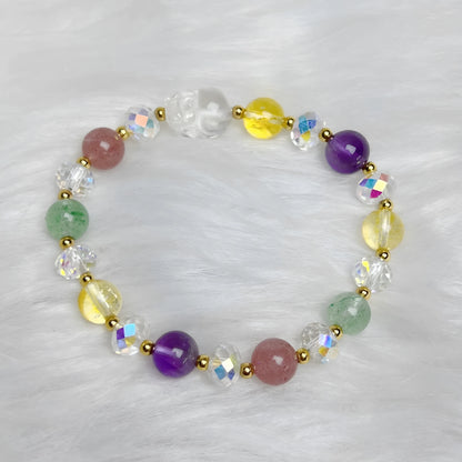 Close-up of a handmade crystal bracelet with a detailed nine-tailed fox design on a wrist.