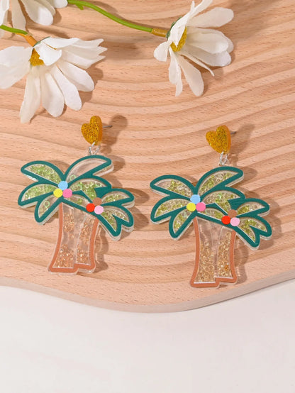 A pair of colourful acrylic earrings shaped like a strawberry and a cherry on a woman's ear.