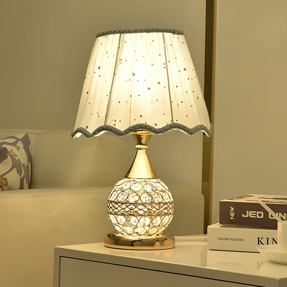 Gold crystal desk lamp with hand-cut facets and remote control on wooden surface