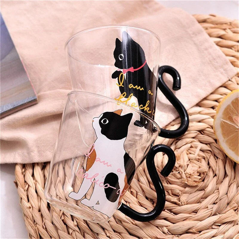 Adorable cat-themed glass mug with a whimsical cat-shaped handle, perfect for coffee, tea, and juice lovers