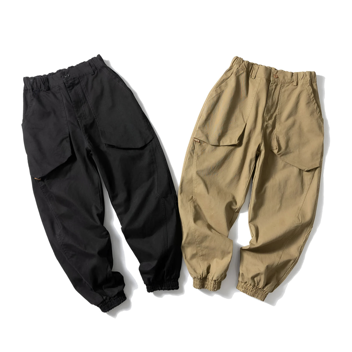 Solid colour cotton casual pants with large pockets and a tapered, ankle-tied silhouette.