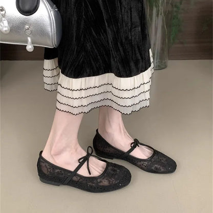 Pink Mary Jane evening shoes with flat lace, mesh upper, and a mid heel on a rubber sole.