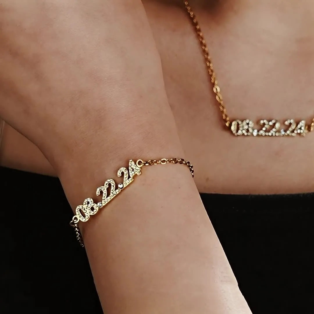 Stainless steel digital bracelet with diamond-set numbers on a wrist, showing gold, rose gold, and steel colour options.