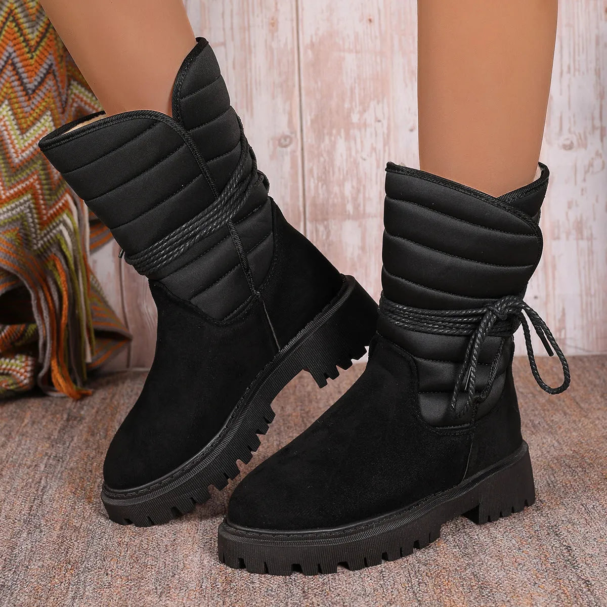 Women's black suede snow boots with chunky heel, fleece lining, and lace-up design for winter wear
