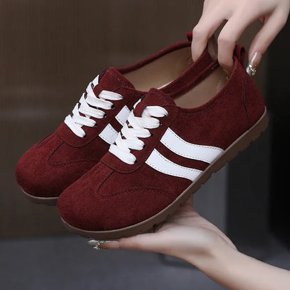 Women's vintage canvas sneakers in dark red with a round toe and flat rubber sole.