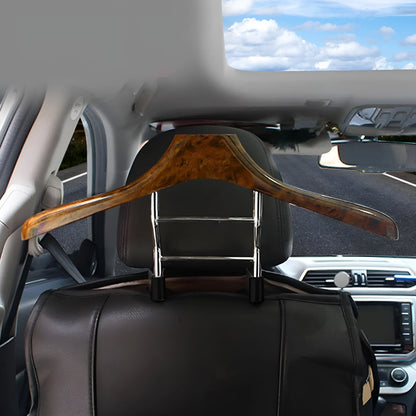 Wood yellow stainless steel car clothes hanger for suits and jackets on a car headrest.