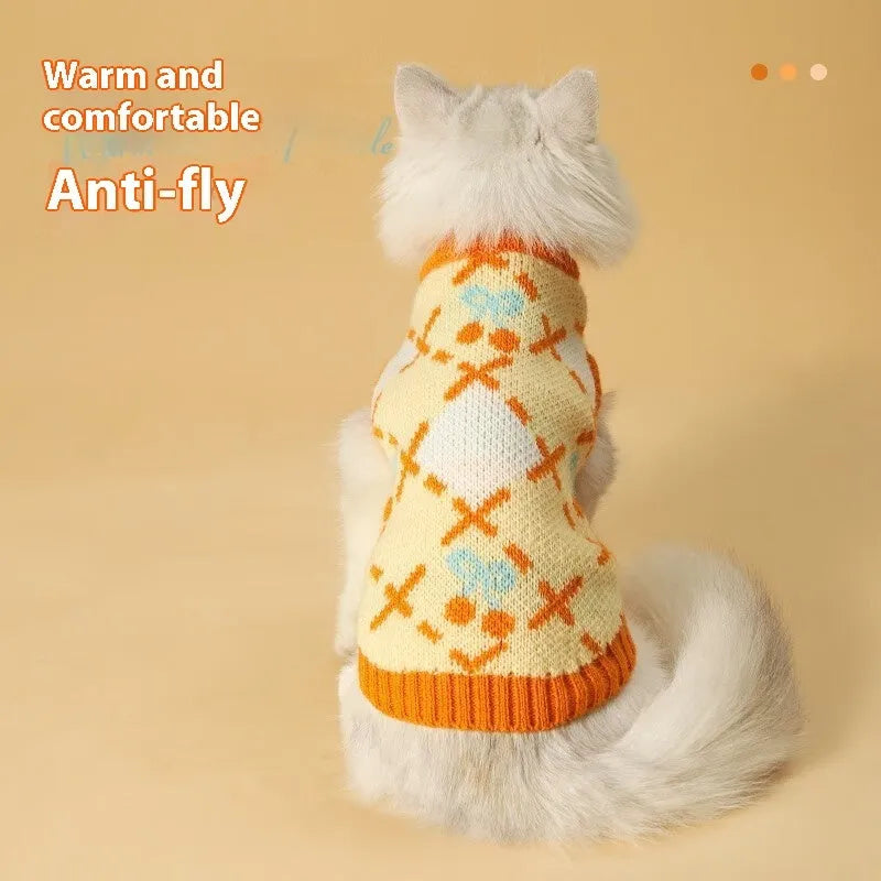 Orange cherry diamond pattern cat sweater shown on feline model with size label