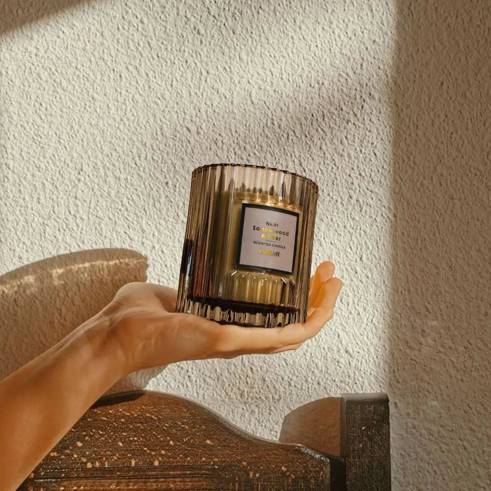 Soy wax aromatherapy candle in cylindrical shape showing red, green and amber colour options