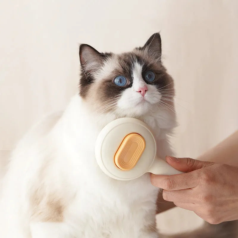 Green and yellow handled cat grooming brush with stainless steel pins on a white background