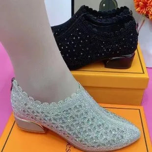 Women's chunky heel shoes with hollow-out upper, frosted full diamond detailing, round toe, canvas upper, and rubber sole.