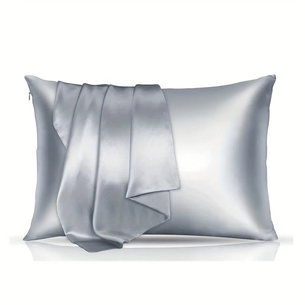 Pair of solid colour satin pillowcases showing smooth plain weave texture and reactive dye colour