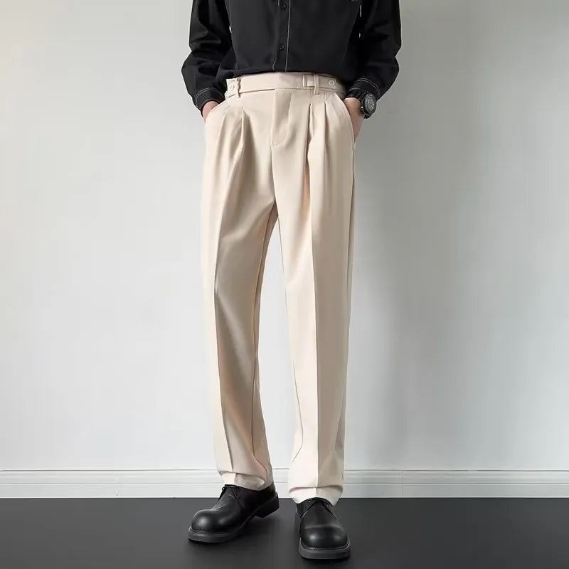 Men's apricot and black straight-leg loose-fit trousers laid flat, showing waistband and full leg.