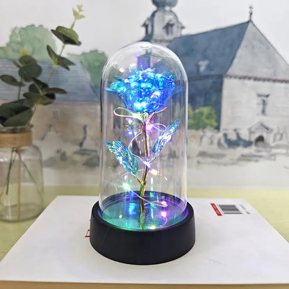 Glass cover small night lamp with plastic flowers, 15cm height, black base, showing colour light options