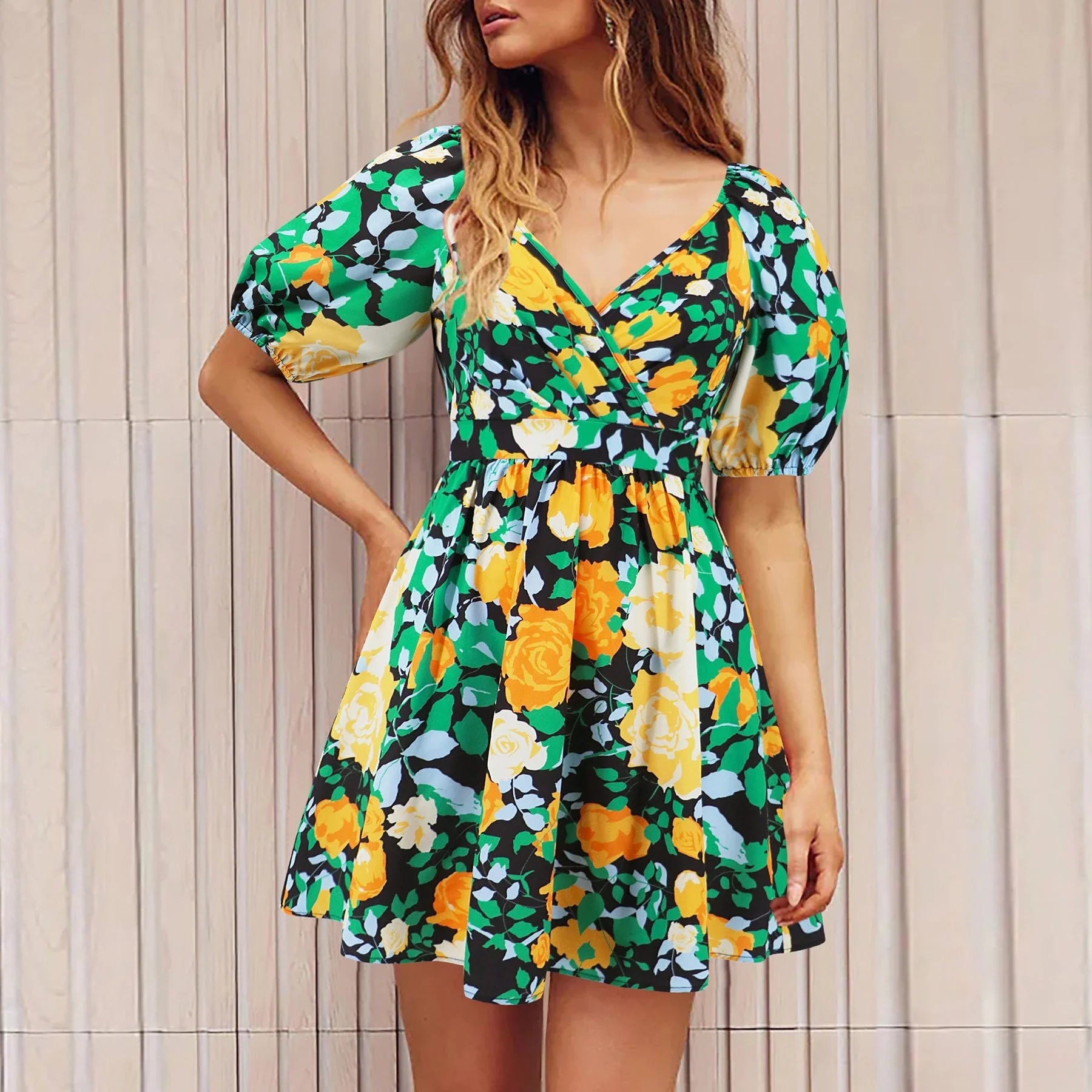 Stylish floral mini dress with V-neck and lantern sleeves, perfect for summer vacations and beach outings