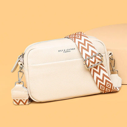 Stylish crossbody bag with rhombus embroidery, wide adjustable shoulder strap, and multiple interior pockets in various color options