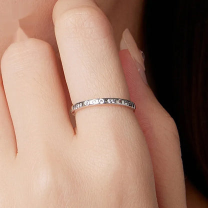 Silver alloy Moss Password I Love You ring with oxidised black finish, shown in size 7 on a model finger.