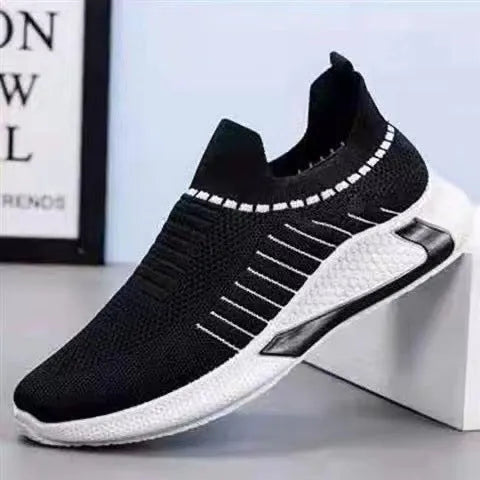 Men's black and white striped slip-on sneakers with lace-up front and mesh upper.