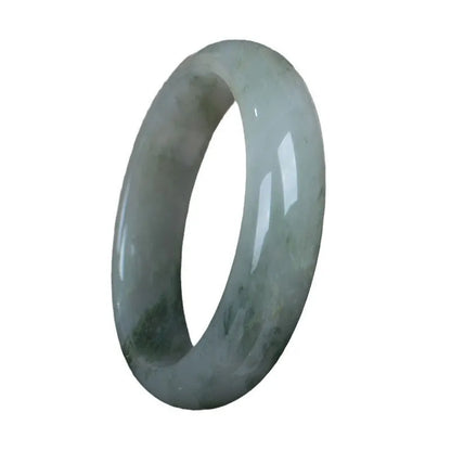 Natural Jinsi Jade Chinese bracelet in a closed bangle design on a plain background.