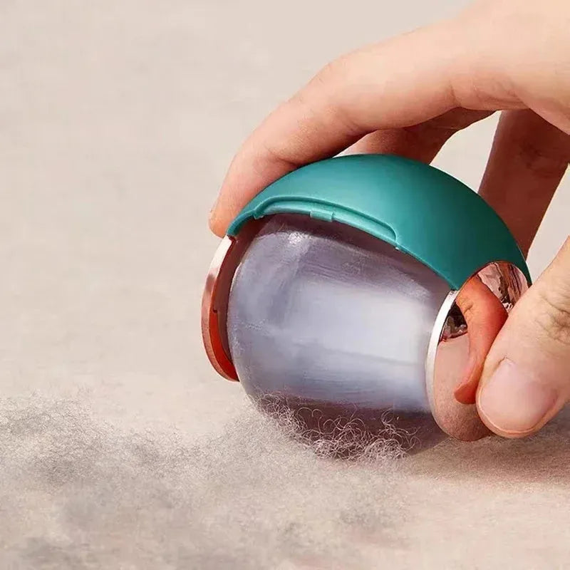 Washable reusable lint roller ball with handle for removing pet hair from fabrics.