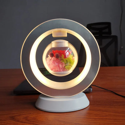Pink rose eternal flower floating in magnetic levitation LED night light with triangular base and touch control