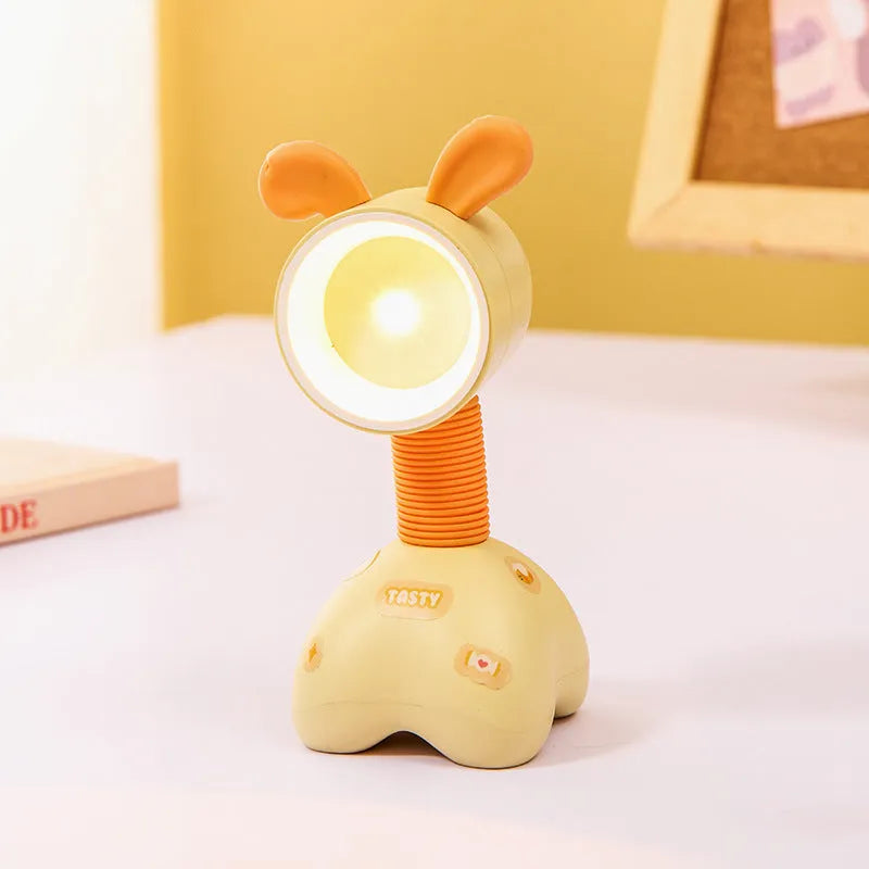 Colourful cartoon character magnetic DIY night light on a desk with adjustable head.