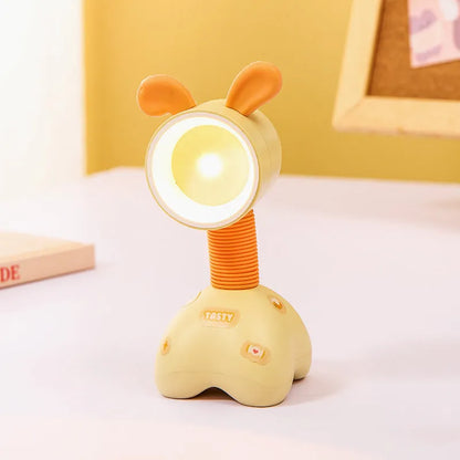 Colourful cartoon character magnetic DIY night light on a desk with adjustable head.