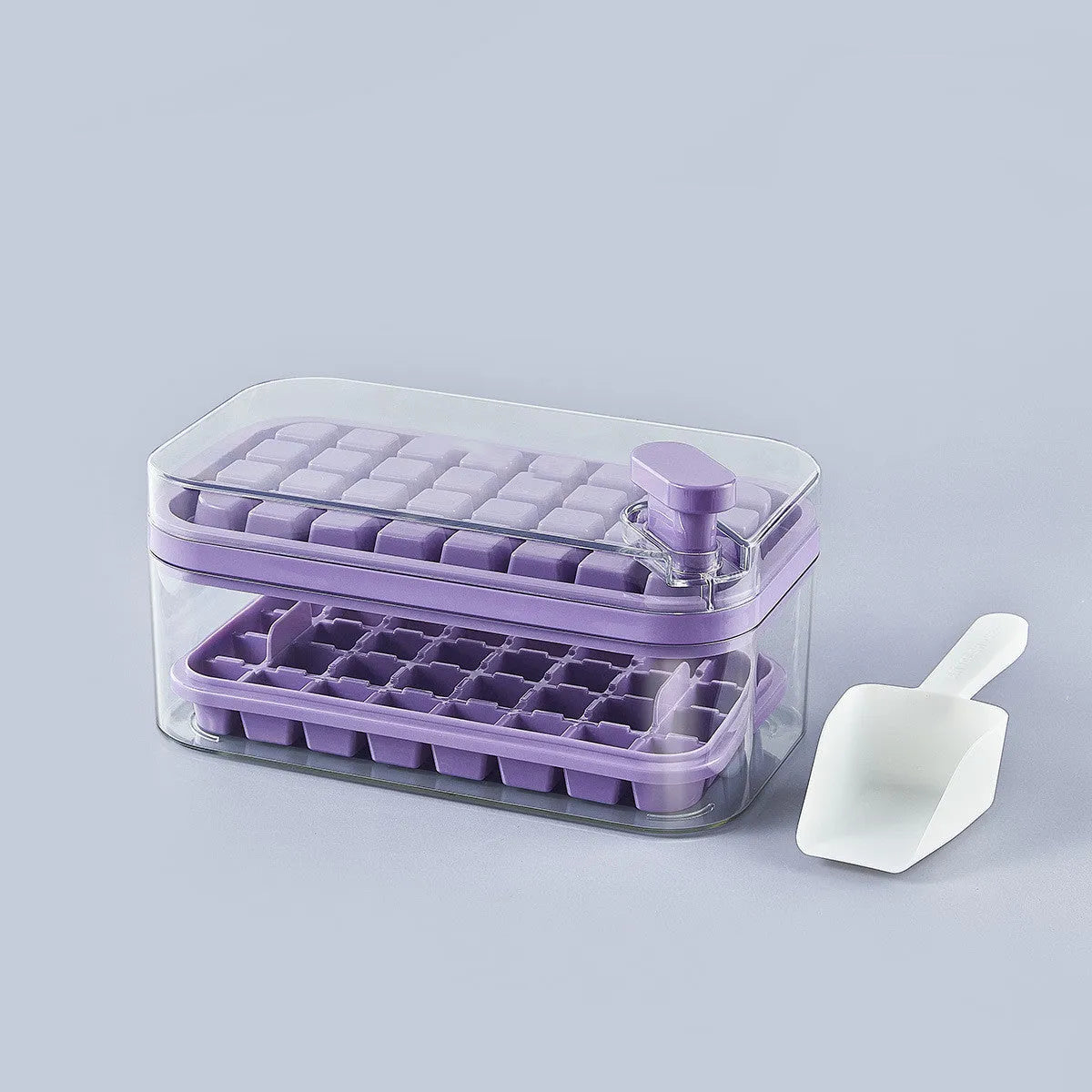 Green one-button press ice mould box with storage lid and ice shovel on kitchen counter