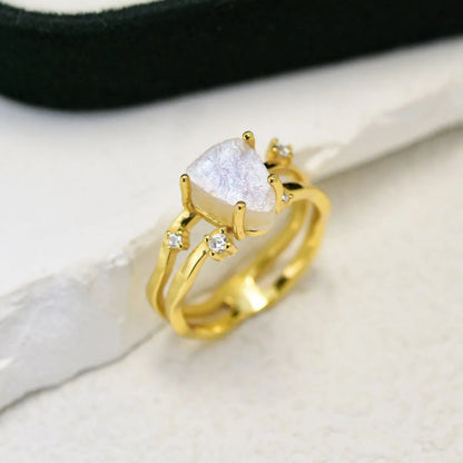 S925 sterling silver ring with an irregular triangular bezel holding a genuine cabochon moonstone, on a model's finger.