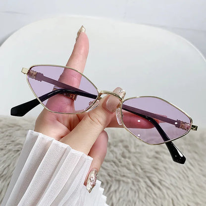Gold metal frame rhombus-shaped cat eye sunglasses on a neutral background.