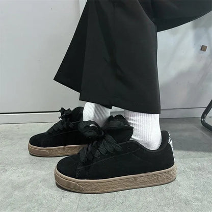 Black retro low-top sneakers with artificial PU upper, round toe and lace-up front closure on rubber sole