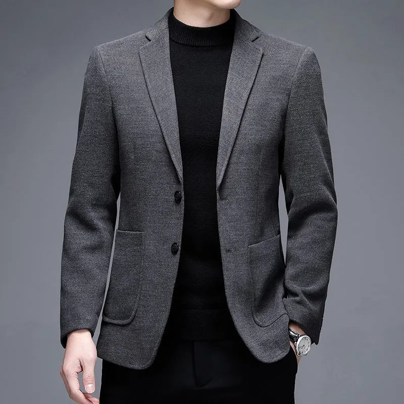 Man wearing a solid colour loose-fit suit-style winter jacket.